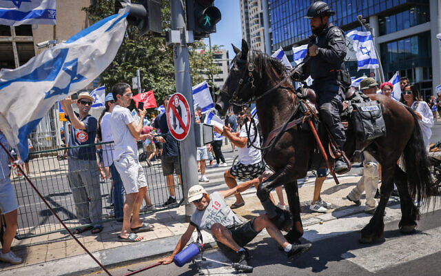شرطي صهيوني على حصان يدوس متظاهر